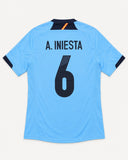 Back of Spain 2012-13 away kit with Andres Iniesta name and number, vintage football shirt, size M, flat lay